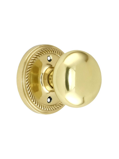 Rope Rosette Style Door Set With Round Brass Knobs in Unlacquered Brass.